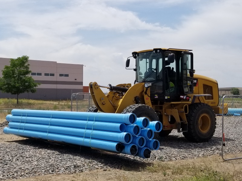 Brighton Core Pipeline Construction Heavy equipment moving blue pipes
